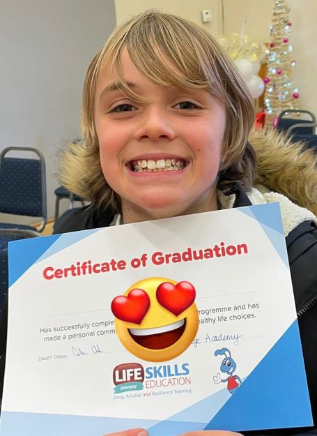 Young boy with his certificate of braduation - supporting our school fundraising ideas